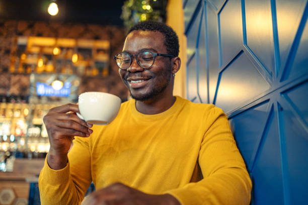 istock Cheerful young man with drinkig coffee 1920322343