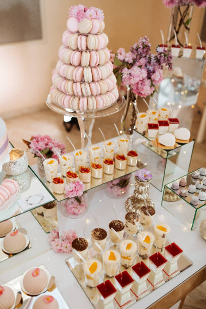 istock Delicious wedding reception candy bar dessert table full with cakes and sweets and flowers Chinese cherry blossoms on the background of an exquisite restaurant 1920323900