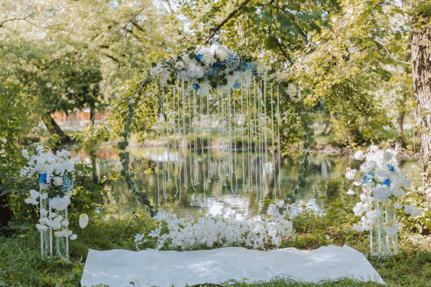 istock A place for a wedding ceremony in a park, with white and blue flowers outdoors. Spring wedding by the lake 1920324962