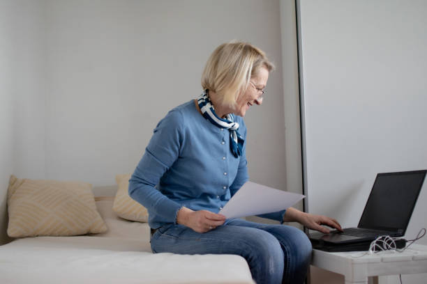 istock mature blond woman working on laptop planning finances 1920325489