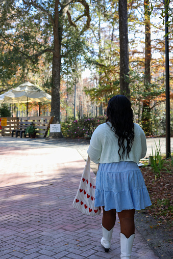 A portrait of a black woman walking in a park