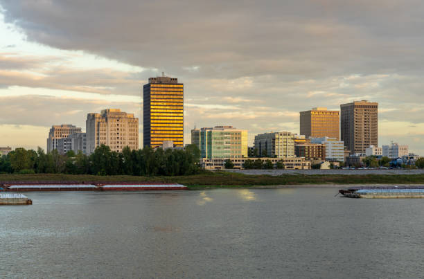 istock Skyline of Baton Rouge at sunset over river barges 1920348851