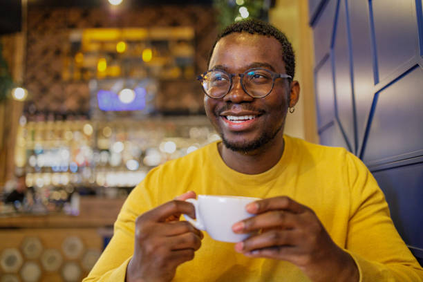 istock Happy man drinking a cup of coffee at a cafe 1920359298