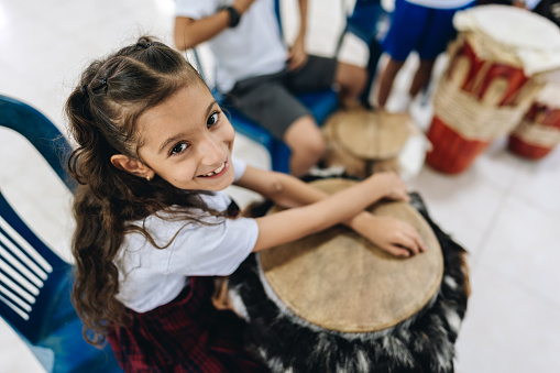 Portrait of a child girl in music class at school
