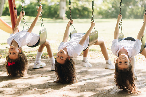 Portrait of child girls on the swing at playground