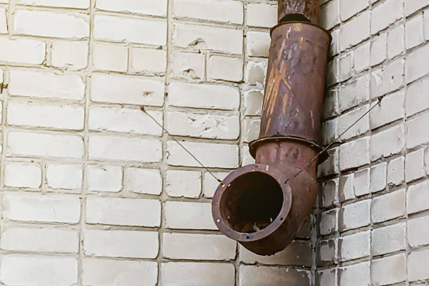 faulty leaking crazy rusty drain on the wall made from scrap materials