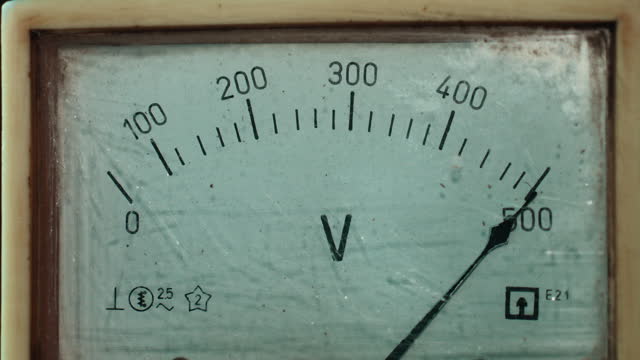 Old analogue voltmeter measuring the voltage of electricity. Close-up analog signal indicator with arrow. Electrical measuring and control device