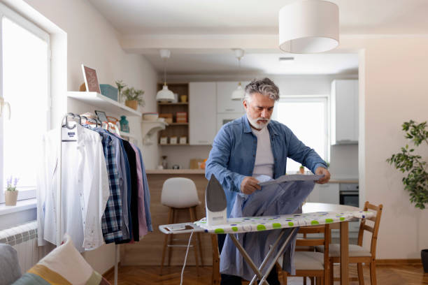 istock Mature Man Ironing Clothes at Home 1920387987