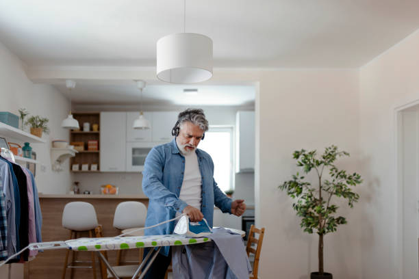 istock Mature Man Ironing Clothes at Home 1920391548