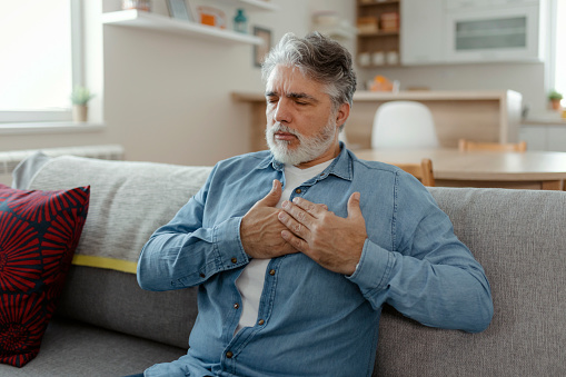 Mature man having heart attack at home