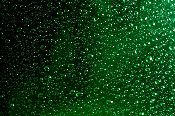 Abstract photography with water drops with reflections on green, close-up background, macro photography