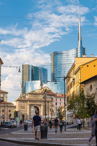 Milan, Italy - August 10, 2017: Milan city, Unicredit tower, tallest italian skyscraper, headquartered of the international banking group Unicredit with branches in 18 other countries in the world. Corso Garibaldi with the contrast between the ancient arch of Porta Garibaldi and the modern skyscrapers