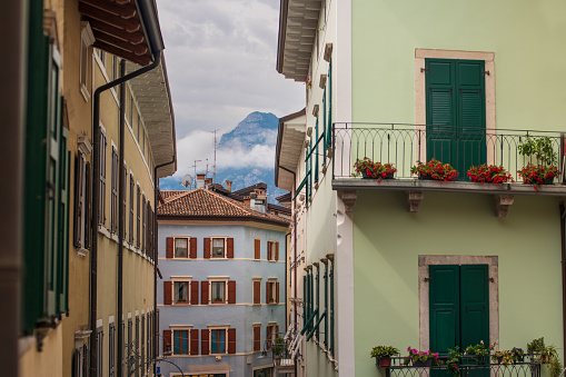 Colorful houses against the backdrop of mountains in the city of Arco Italy
