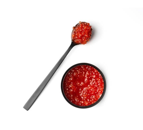 red salmon caviar in a black tin can and black spoon on a white background - caviar salmon red gourmet ストックフォトと画像