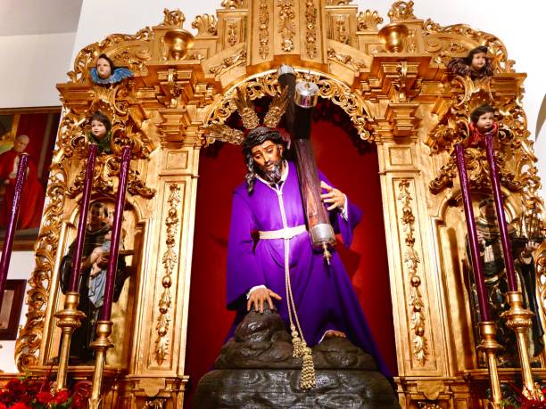 istock Jesus in purple holding a cross 1920477401