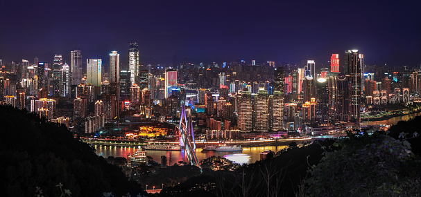 Panorama of night scene of Chongqing city with its business center over the Yangtze River