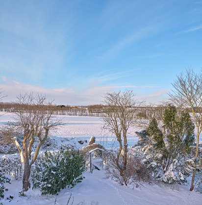 Garden and countryside covered with snow and frost. Denmark in winter.