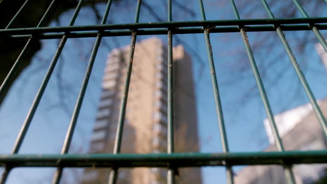 Tower block through metal railings