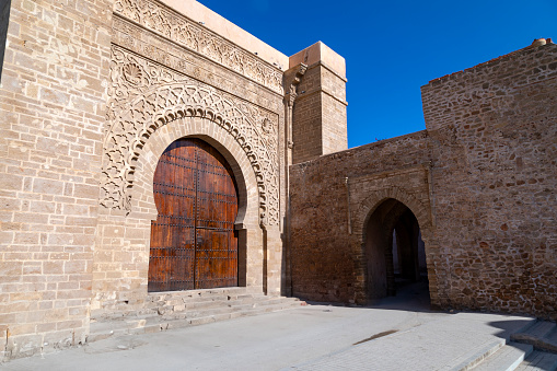 The striking Ouyad Kasbah in Morocco is a fortress that exemplifies traditional Berber architecture. Set against a rugged landscape, this historic structure tells a story of the past, with its earthen construction and distinctive design standing as a testament to Morocco's rich cultural heritage.