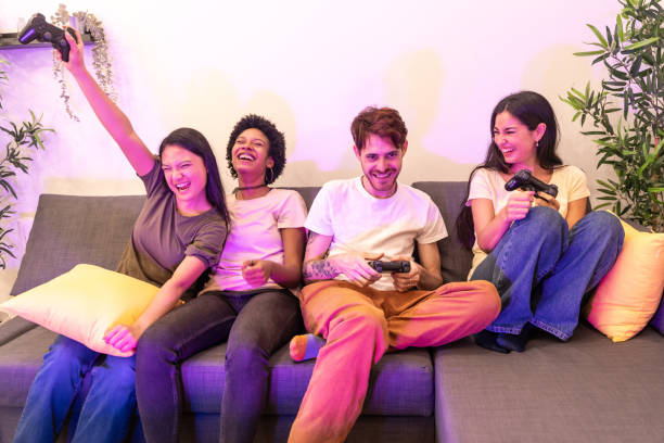 Woman celebrating that wins playing console with friends