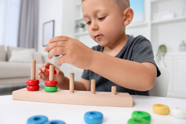 istock Motor skills development. Little boy playing with stacking and counting game at table indoors, closeup 1920580136