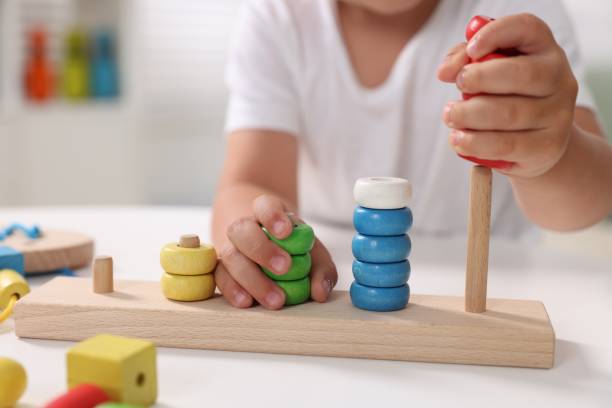 istock Motor skills development. Little boy playing with stacking and counting game at table indoors, closeup 1920583227