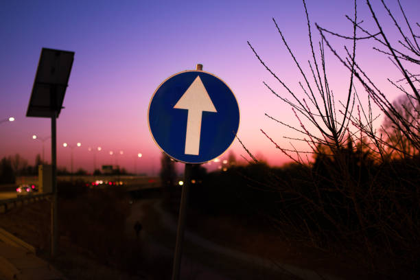 One way sign set against a blue sky