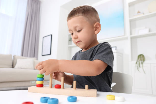 istock Motor skills development. Little boy playing with stacking and counting game at table indoors 1920607039
