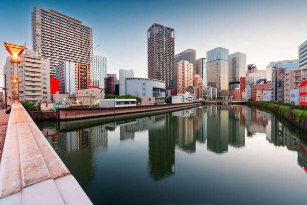 Osaka, Japan cityscape on the river at dusk.