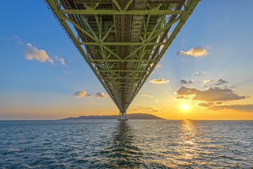 Akashi Kaikyo Bridge spanning the Seto Inland Sea from Awaji Island to Kobe, Japan at sunset.