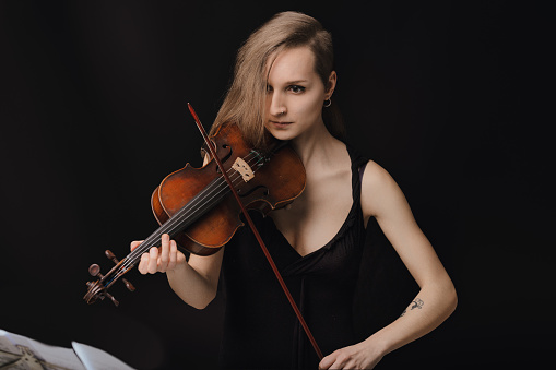 violinist's focused expression conveys the depth of her performance, highlighting the intimate bond with her instrument