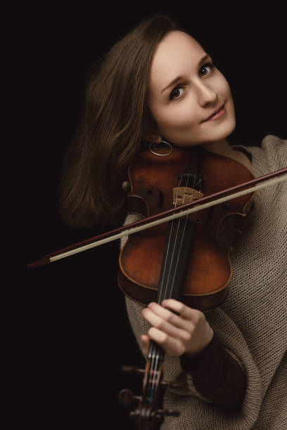 istock Violinist's tender smile reveals deep musical engagement 1920729092