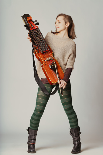 The player's poise and the nyckelharpa's elegance combine to tell a story of musical devotion and cultural legacy
