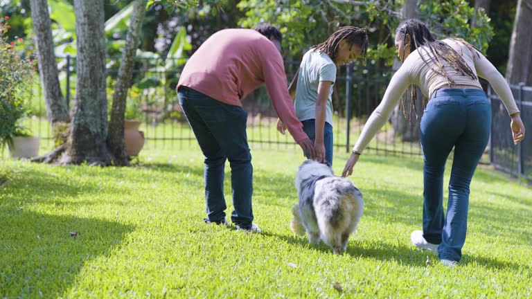 African-American family with dog in back yard