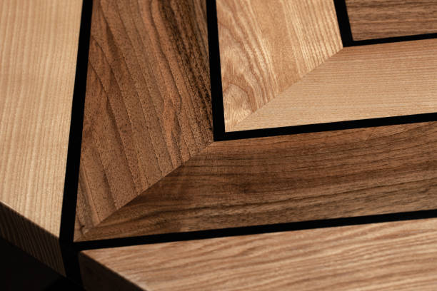 istock The table is covered with epoxy resin and varnished. Luxury quality wood processing. Wooden table on a dark background. Swirling geometric patterns in the form of a maze. 1920802530