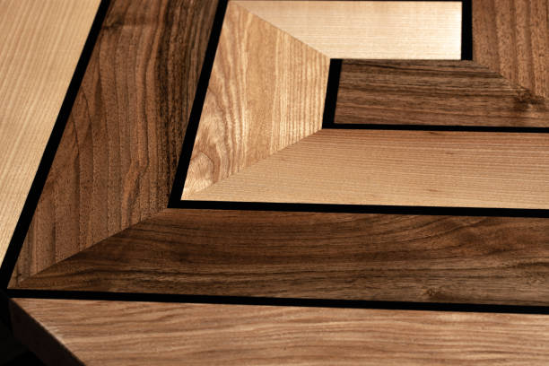 istock The table is covered with epoxy resin and varnished. Luxury quality wood processing. Wooden table on a dark background. Swirling geometric patterns in the form of a maze. 1920802533