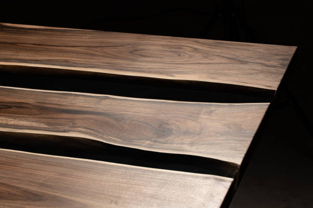 istock The table is covered with epoxy resin and varnished. Luxury quality wood processing. Wooden table on a dark background. Business proposal concept. 1920803074