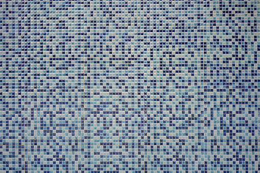 Background of grey and turquoise rectangular tiles of different texture