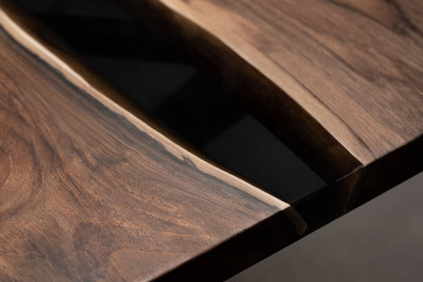 istock The table is covered with epoxy resin and varnished. Luxury quality wood processing. Wooden table on a dark background. Business proposal concept. 1920805657