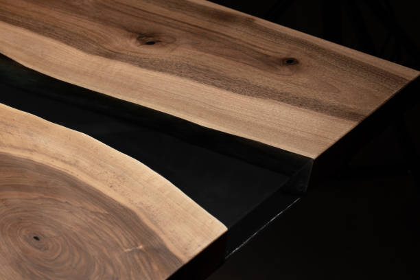istock The table is covered with epoxy resin and varnished. Luxury quality wood processing. Wooden table on a dark background. Business proposal concept. 1920808764