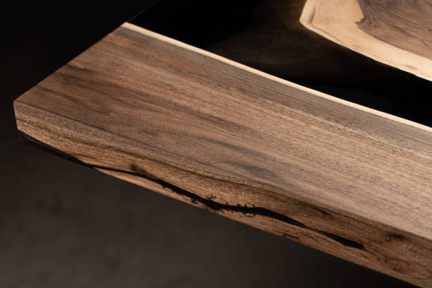 istock The table is covered with epoxy resin and varnished. Luxury quality wood processing. Wooden table on a dark background. Business proposal concept. 1920810848