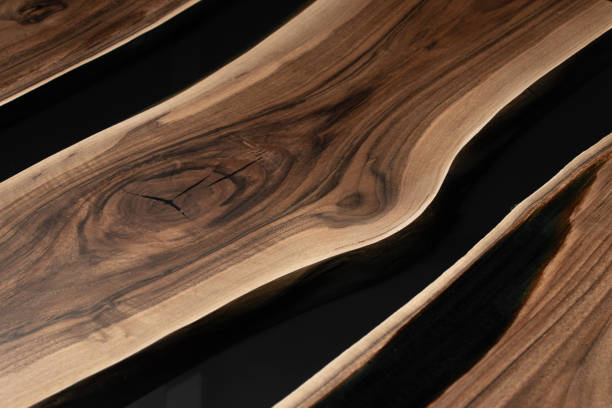 istock The table is covered with epoxy resin and varnished. Luxury quality wood processing. Wooden table on a dark background. Business proposal concept. 1920823771