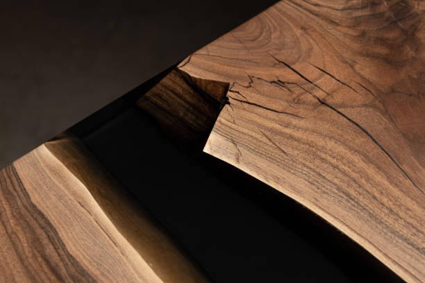 istock The table is covered with epoxy resin and varnished. Luxury quality wood processing. Wooden table on a dark background. Business proposal concept. 1920825841