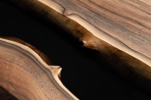 istock The table is covered with epoxy resin and varnished. Luxury quality wood processing. Wooden table on a dark background. Business proposal concept. 1920825955