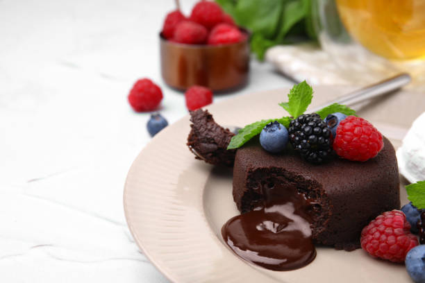 istock Delicious chocolate fondant served with fresh berries on white textured table, closeup. Space for text 1920850154