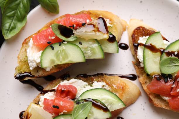 istock Delicious bruschettas with balsamic vinegar and toppings on plate, flat lay 1920865151