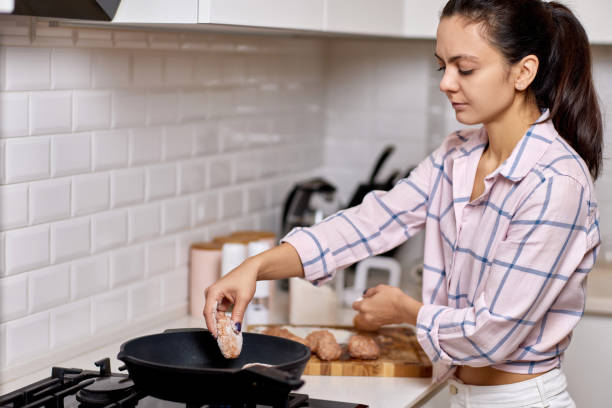 istock Woman preparing meat cutlets in the kitchen 1920881531