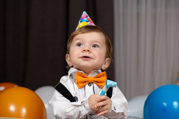 Funny one-year-old red-haired boy on his birthday.