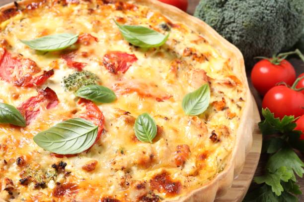 istock Tasty cheese quiche and ingredients on table, closeup 1920922911