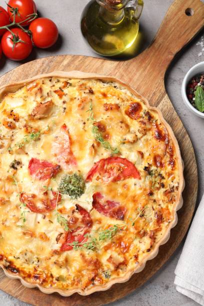 istock Tasty cheese quiche and ingredients on light grey table, flat lay 1920922913